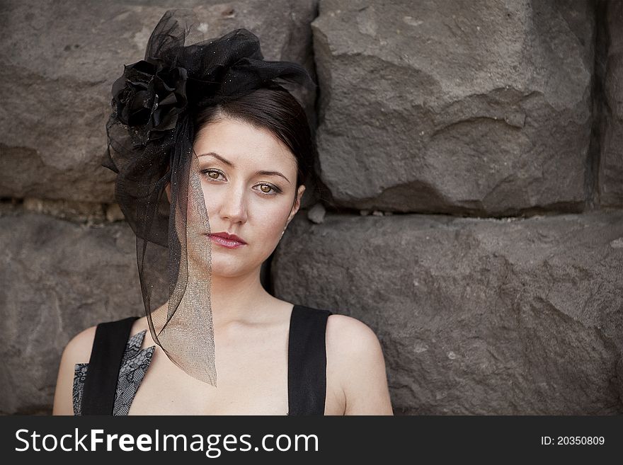 Retro-stylized woman in black hat with veil and black dress.