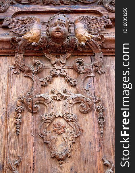 Old carved wooden door of the church Parroquia Castrense De La Ciudadela in Ciutadella Park , Barcelona, Spain