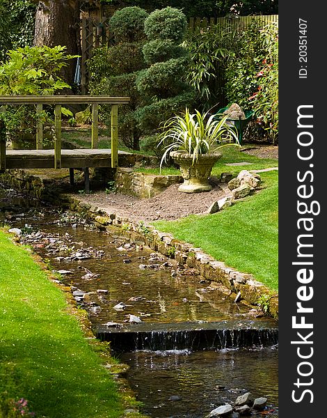 Small stream flowing through a country garden