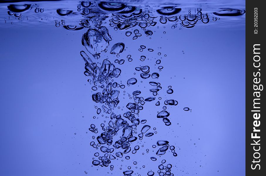 Bubbles in blue water macro shot. Bubbles in blue water macro shot