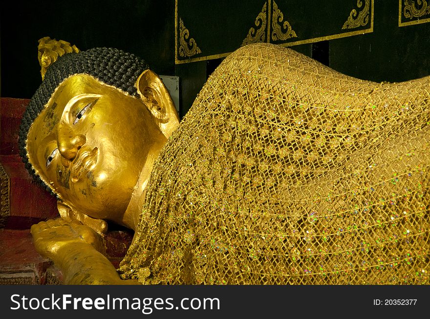 Beautiful golden buddha in sleeping posture, Chiangmai Thailand.