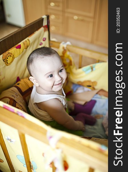 Cute baby girl s playing with toys in playroom