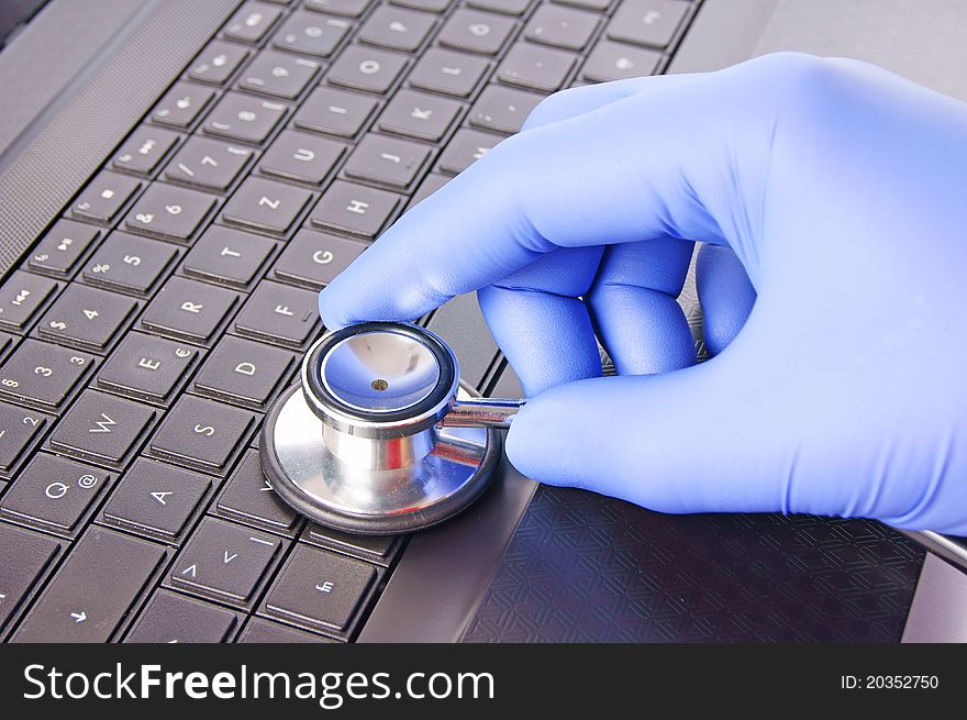 Stethoscope and laptop with hand. Stethoscope and laptop with hand