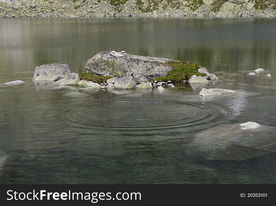 Frog rock in a mountain lake in the High Tatras National Park, Slovakia. Frog rock in a mountain lake in the High Tatras National Park, Slovakia.