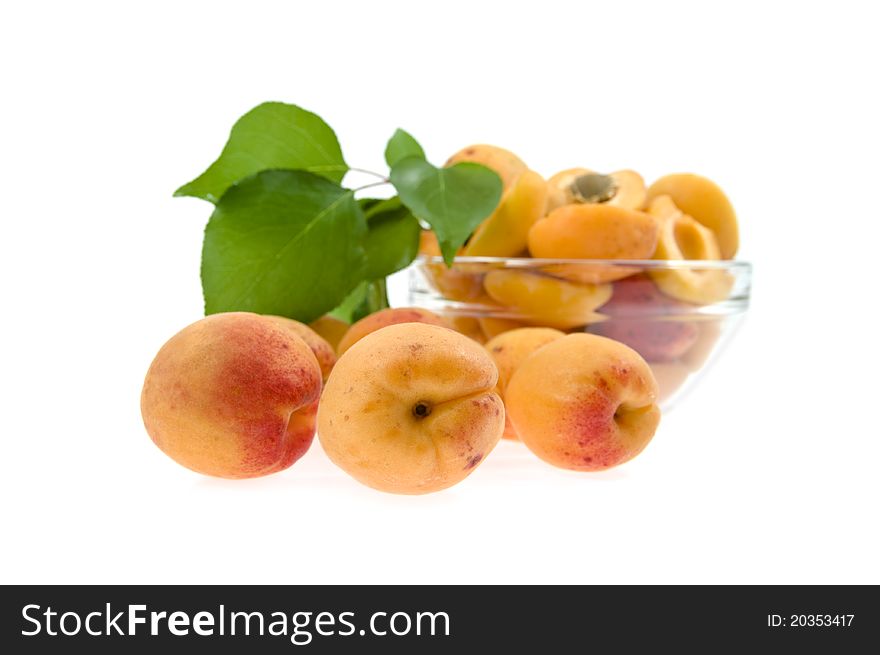 Apricots  lie on a background a dish with a half apricot isolated. Apricots  lie on a background a dish with a half apricot isolated