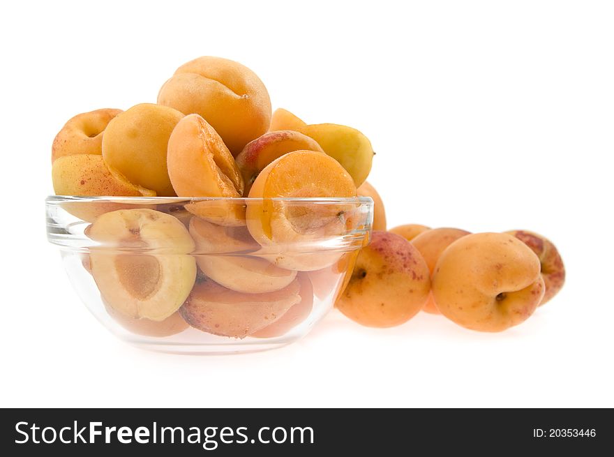 Apricots lie a half in a dish on a background a heap apricot isolated