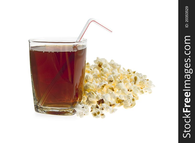 Glass with drink and tube on a background pop-corn on a white background