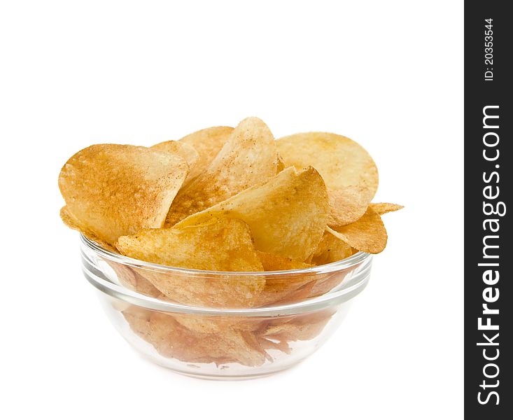 Chips lie in a dish on a white background