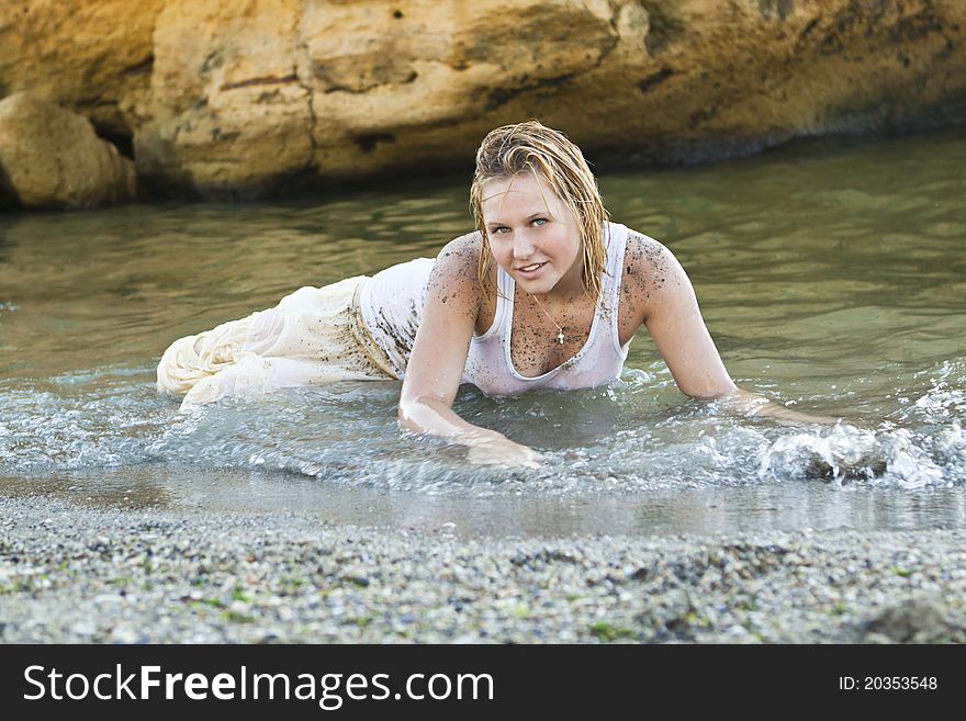 Redheaded girl in a wet white T-shirt