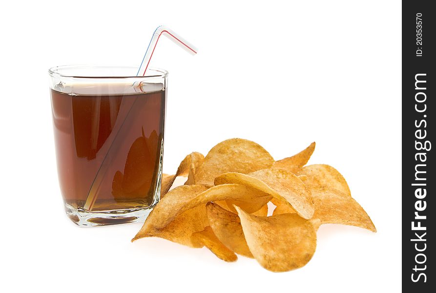 Glass with drink and tube with lying alongside chips on a white background. Glass with drink and tube with lying alongside chips on a white background