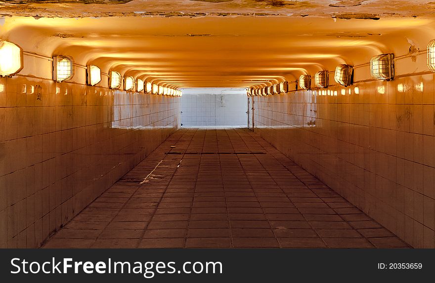 Color view of tiled underground pedestrian passage with light shining through exits. Color view of tiled underground pedestrian passage with light shining through exits.