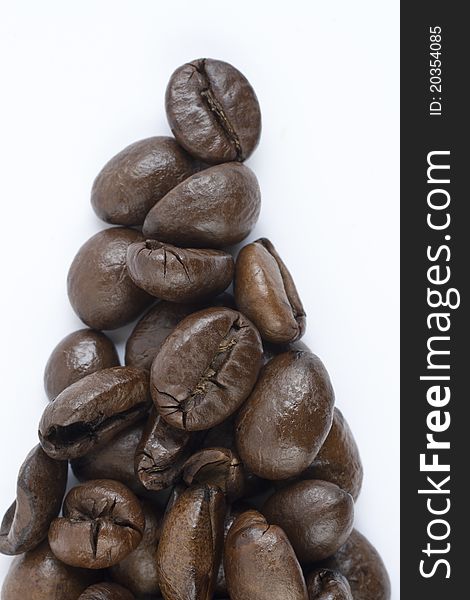 Coffee beans forming triangle on white background. Coffee beans forming triangle on white background