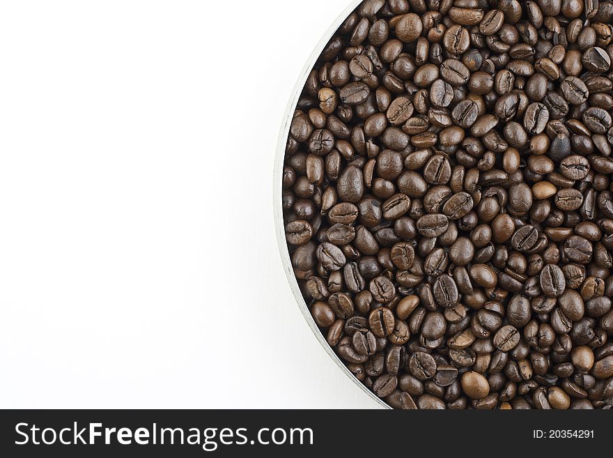 Coffee beans in pan on white background