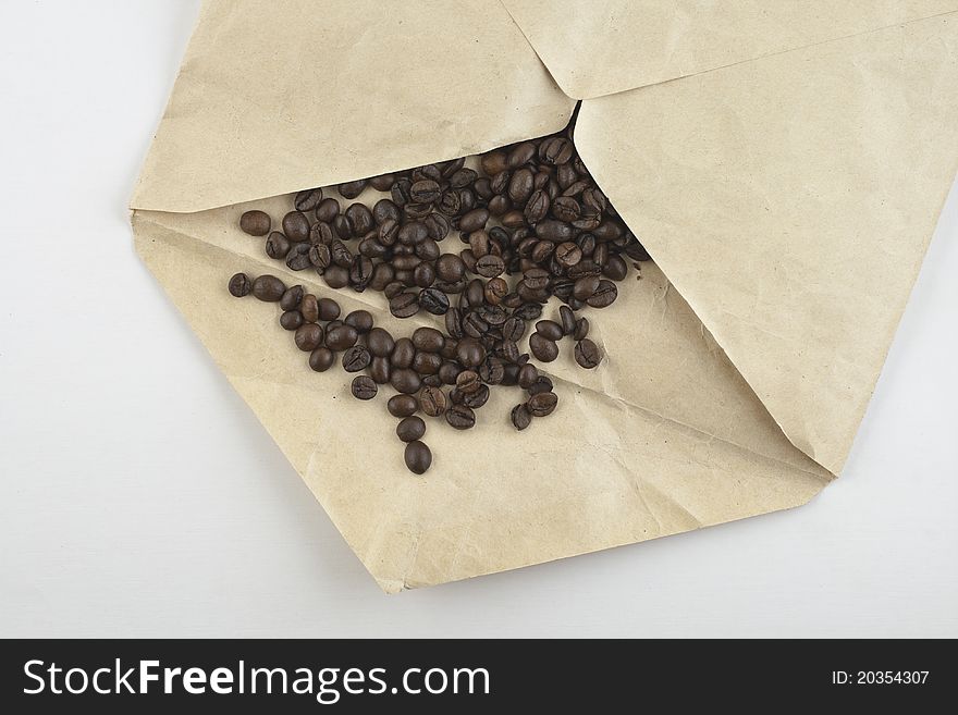 Coffee beans in opened envelope. Coffee beans in opened envelope