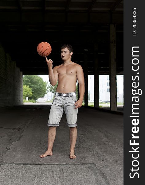 Guy with torso holding basketball on his finger. Guy with torso holding basketball on his finger