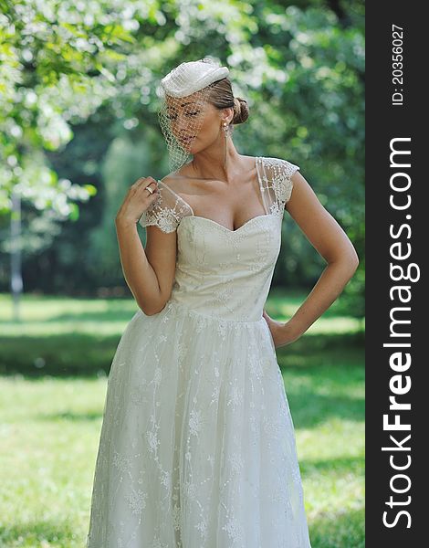 Beautiful bride woman people in fashion wedding dress posing outdoor in bright park. Beautiful bride woman people in fashion wedding dress posing outdoor in bright park