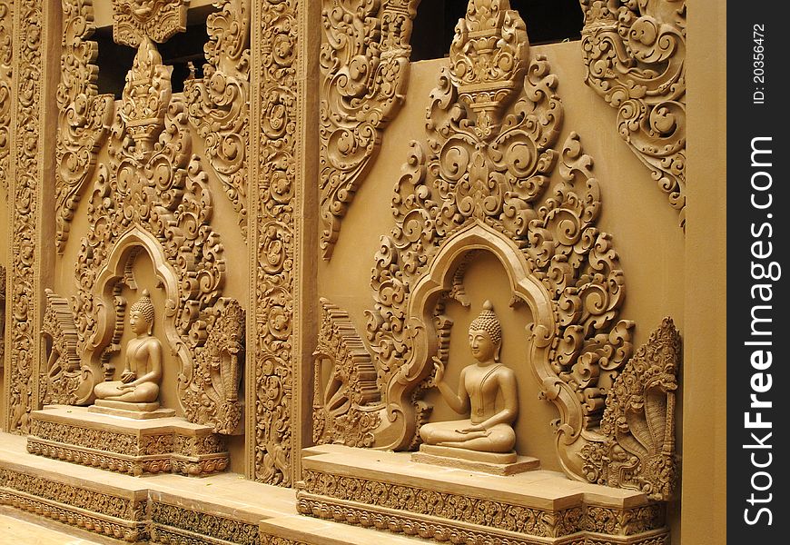 Row of sitting Budhha statues along the wall of a temple in Kanchanaburi, Thailand. Row of sitting Budhha statues along the wall of a temple in Kanchanaburi, Thailand