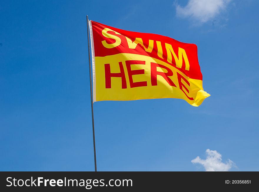 A Swim Here Flag along a beach to signal that it is a safe swim zone