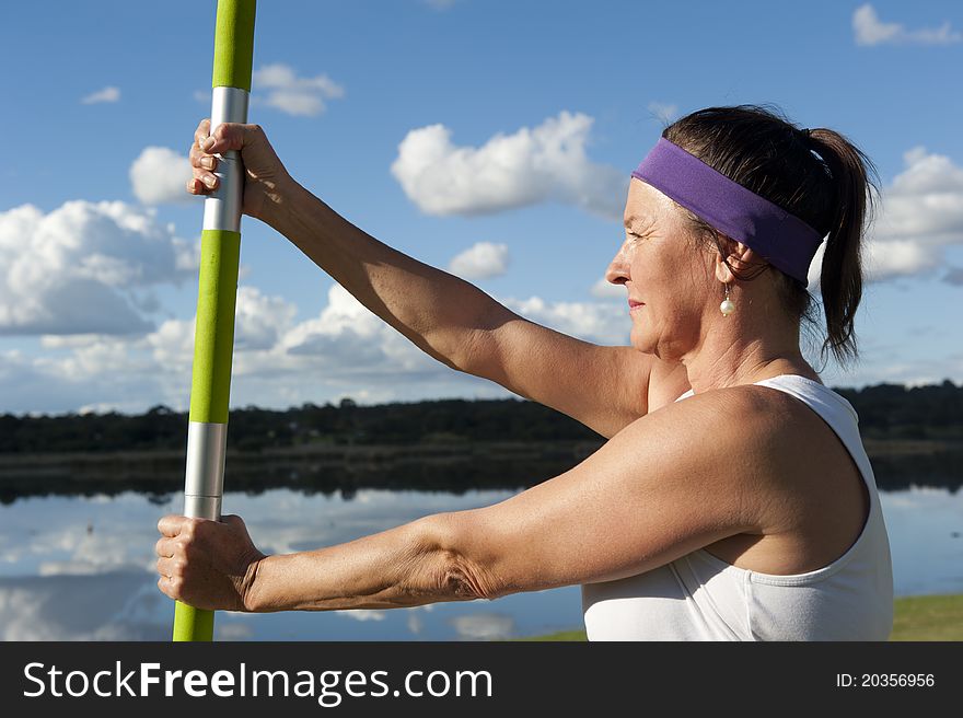 A fit and healthy woman doing her yoga exercises at a lake. A fit and healthy woman doing her yoga exercises at a lake.