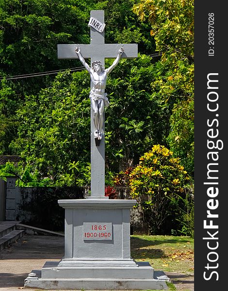 A depiction of Jesus Christ being crucified on a cross, all in silver, outside a Catholic Chucrh in the small fishing town of Anse La Raye on the Caribbean island of ASt. Lucia. A depiction of Jesus Christ being crucified on a cross, all in silver, outside a Catholic Chucrh in the small fishing town of Anse La Raye on the Caribbean island of ASt. Lucia.