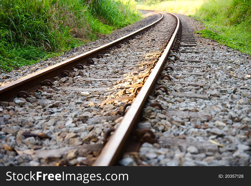 A railway track through a forested valley. A railway track through a forested valley