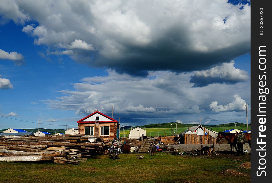 Log Cabin under blue sky and white clouds.