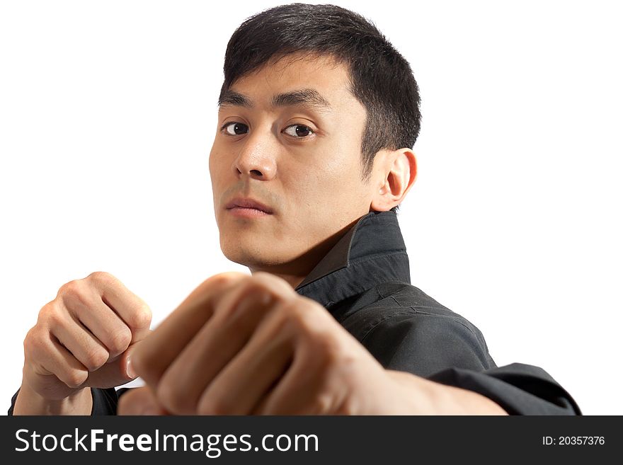 A martial artist posing with fists raised. A martial artist posing with fists raised