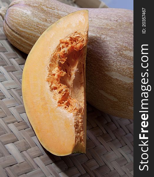 This is a be cut into slices, the mature, but not processed pumpkin, background is a whole pumpkins.