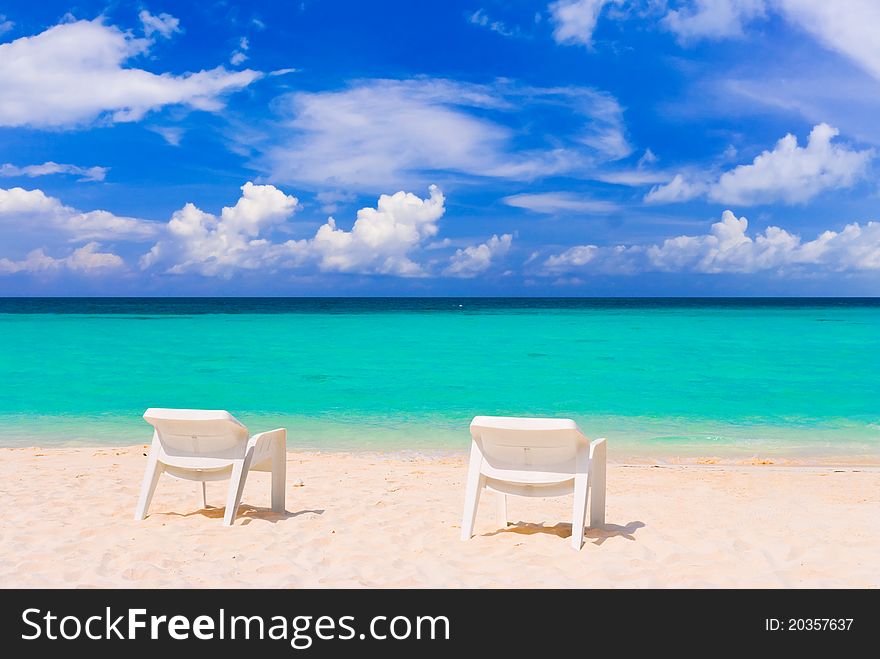 Chairs on tropical beach - abstract vacations background