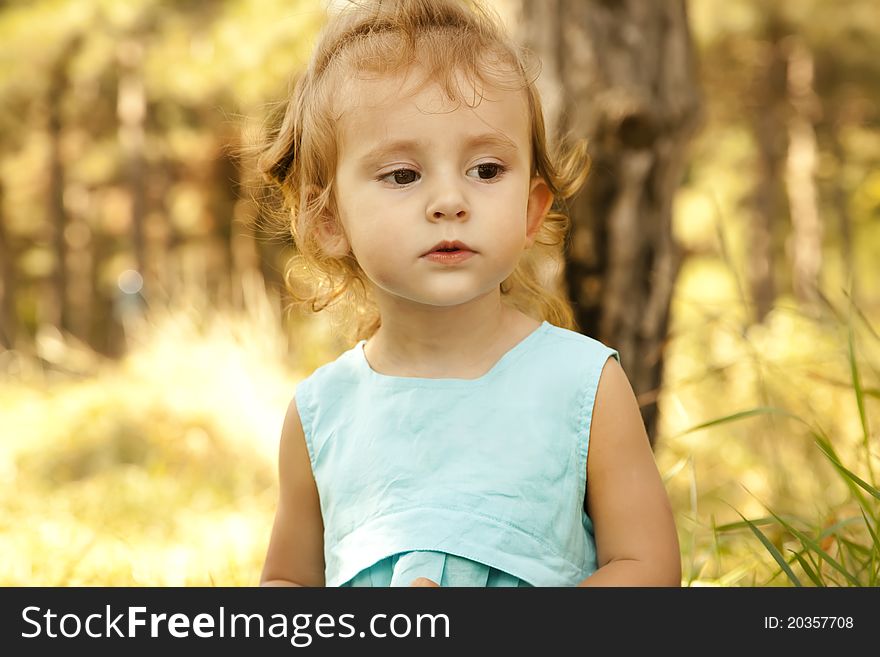 Cute little girl smiling in a park