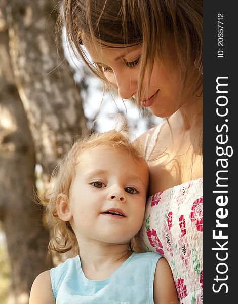 Little girl and mother in the park.