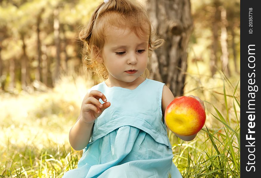 Cute little girl smiling in a park.