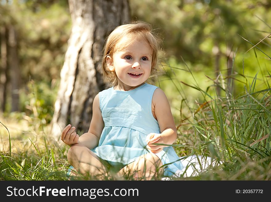 Cute little girl smiling in a park.