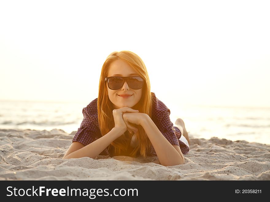 Beautiful girl with headphones at beach sand.