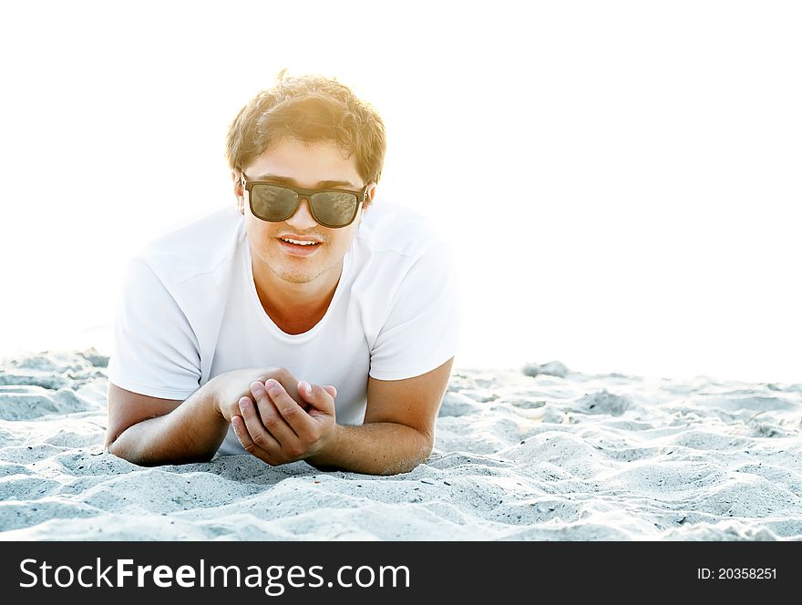 Beautiful brunette men at the beach in sunrise time. Beautiful brunette men at the beach in sunrise time