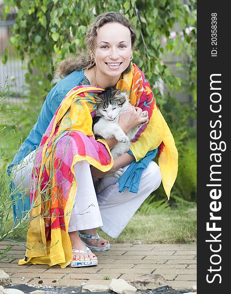 Happy woman holding fluffy cat in her hands. Happy woman holding fluffy cat in her hands
