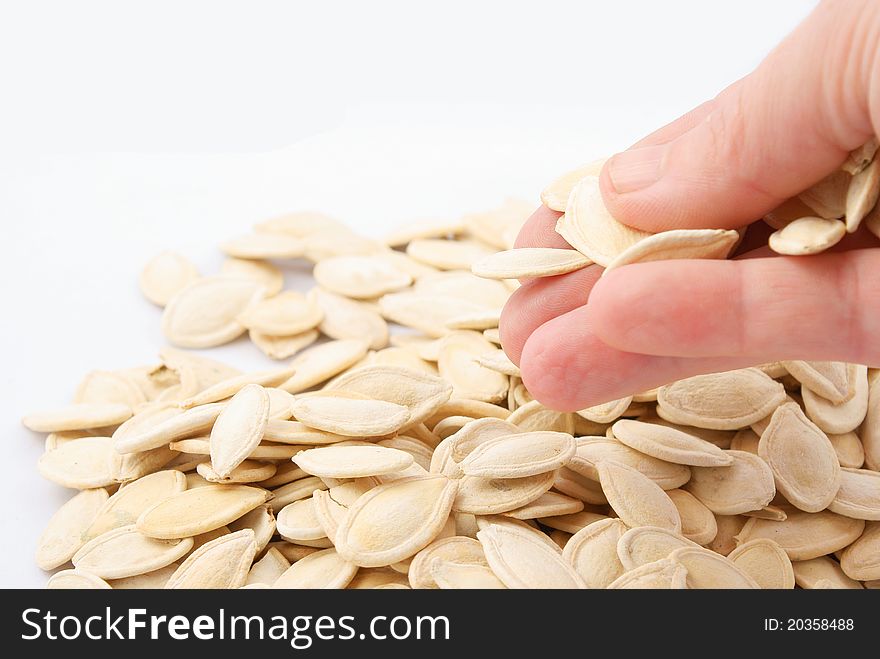Pumpkin seeds in hand isolated on white background. Pumpkin seeds in hand isolated on white background