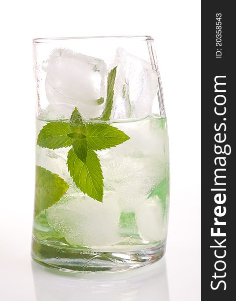 Tall drink with mint and ice on green background