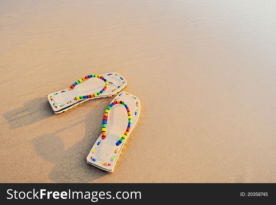 Beach sandals on the sandy sea coast. Beach sandals on the sandy sea coast