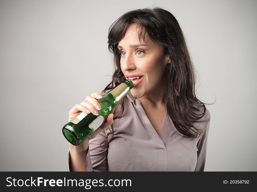 Young woman drinking a beer
