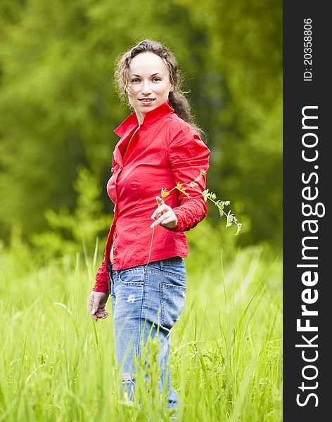 Portrait of beautiful woman against green lawn