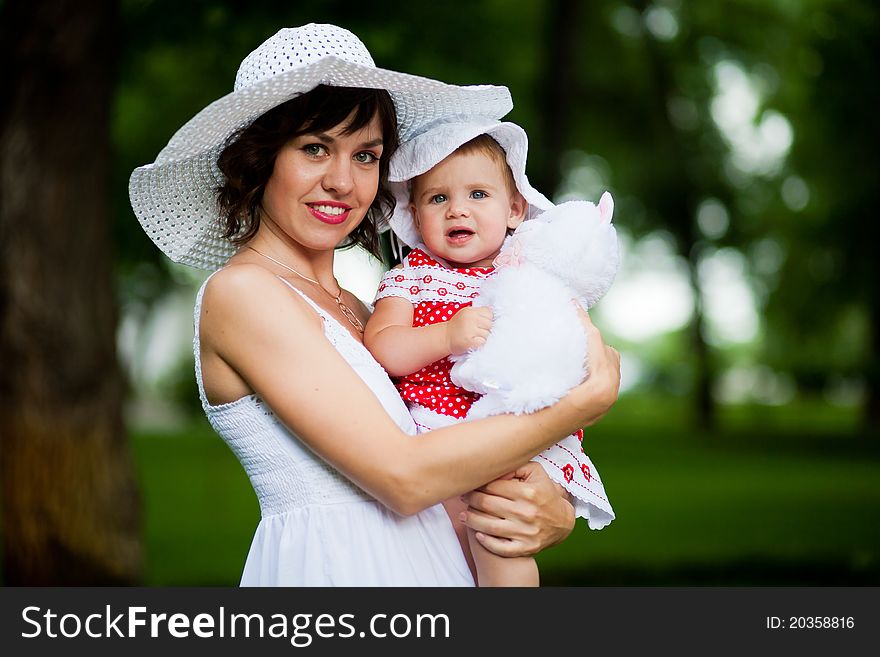 Beautiful young mother and her daughter in the park