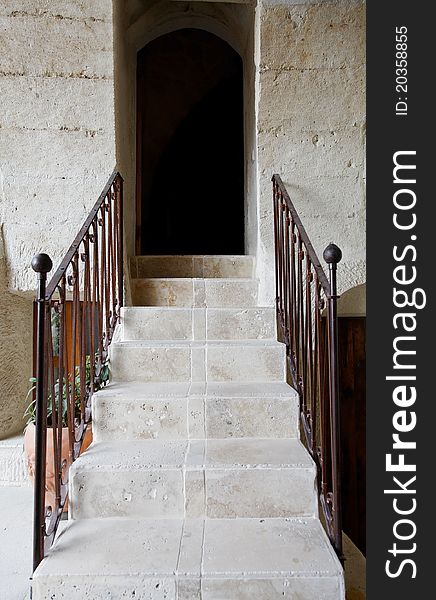 Limestone background and steps with hand rails leading to arched dark doorway, vertical copy space. Limestone background and steps with hand rails leading to arched dark doorway, vertical copy space