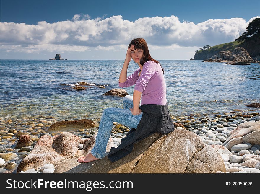 Beautiful young brunette on the beach waiting for a miracle. Beautiful young brunette on the beach waiting for a miracle