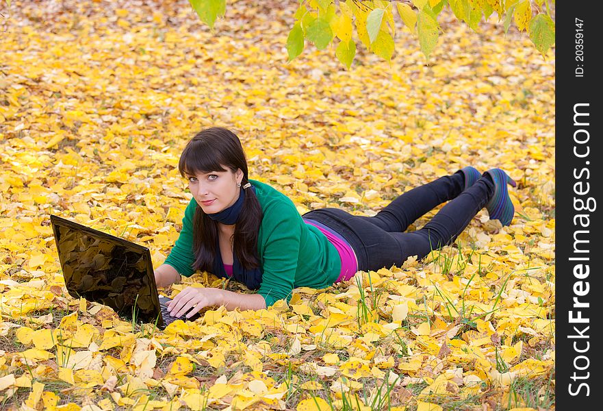 Autumn landscape. beautiful young girl resting in yellow autumn leaves. Autumn landscape. beautiful young girl resting in yellow autumn leaves