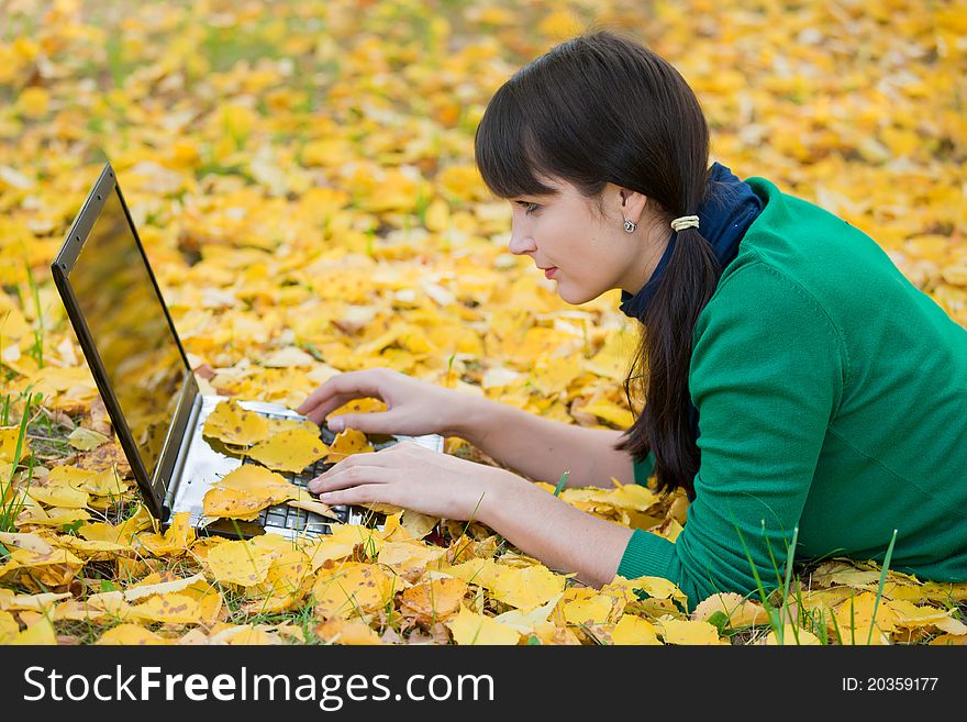 Autumn landscape. beautiful young girl resting in yellow autumn leaves. Autumn landscape. beautiful young girl resting in yellow autumn leaves