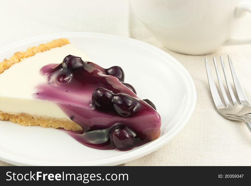 Blueberry cheese pie with coffee cup
