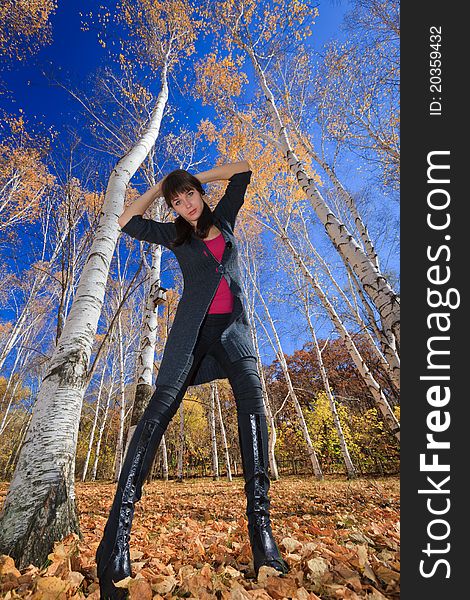 Active Young Girl Resting In A Birch Grove