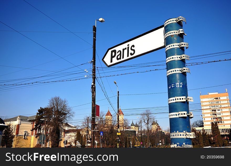 A city direction signs showing the direction and the distance for Paris. The indicator is located in Iasi, a city from Romania. A city direction signs showing the direction and the distance for Paris. The indicator is located in Iasi, a city from Romania