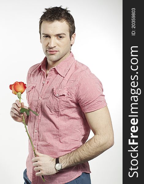 Handsome young man waiting for his date holding a rose. Handsome young man waiting for his date holding a rose